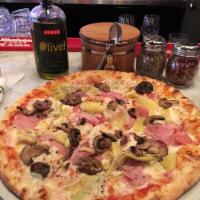 Capricciosa Pizza · Tomato sauce, mozzarella, ham, sauteed mushrooms, and marinated artichokes.