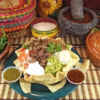 Tostada · Choice of al pastor, chicken, steak or carnitas, tomatoes, beans, lettuce, salsa, guacamole,...