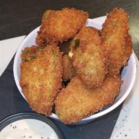 Jalapeno Poppers · House made with sharp cheddar cheese and served with ranch.