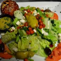 Mediterranean Salad · Fresh romaine with tomatoes, feta, olives, pepperoncini and spicy roasted chickpeas. Served ...