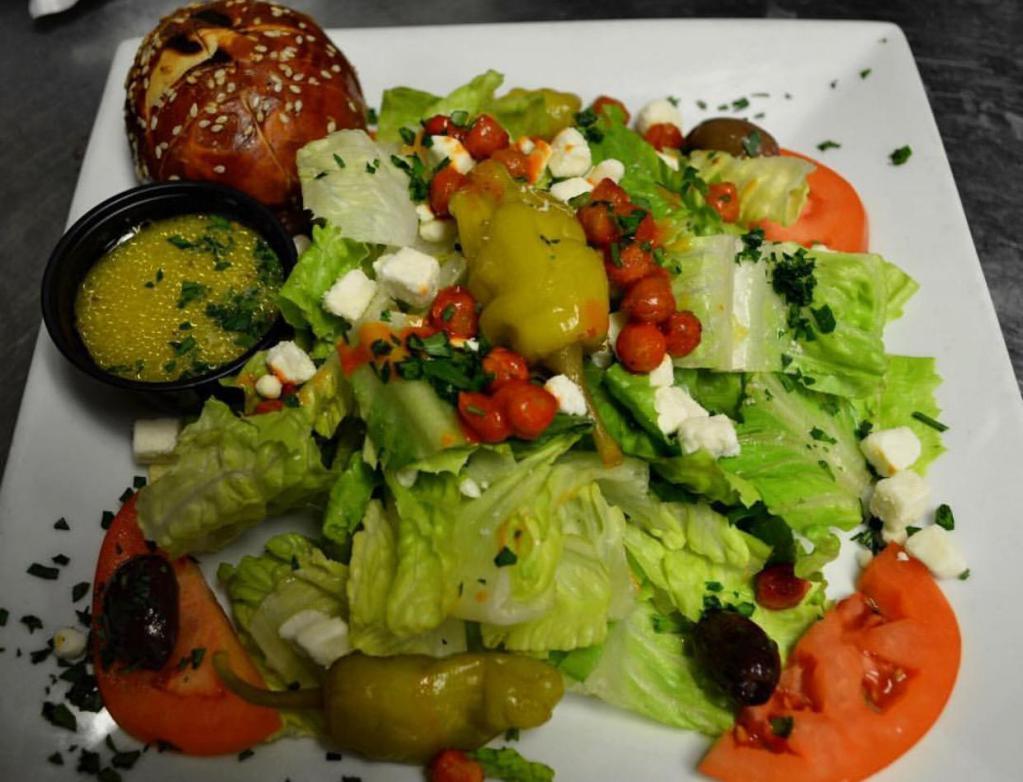Mediterranean Salad · Fresh romaine with tomatoes, feta, olives, pepperoncini and spicy roasted chickpeas. Served with citrus vinaigrette.