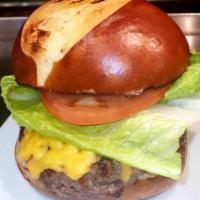 Shep's Classic Burger · Cheddar, pickles, lettuce, tomato and a side of house sauce.