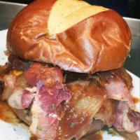 Rodeo Burger · 8 oz. burger patty topped with cheddar cheese, homemade bourbon onions, wild BBQ sauce and b...