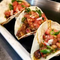 Steak Fajita Tacos · Mix of sauteed peppers, onions and skirt steak with cheddar cheese and pico de gallo.