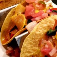 Veggie Tacos · Vegetable medley sauteed with cheddar cheese and pico de gallo.