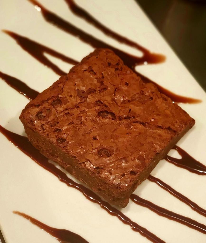 Fudge Brownie · Decadent Chocolate Chip Brownie Made w/ Authentic Belgian Milk Chocolate. Complimented By a Soft, Fudge Texture