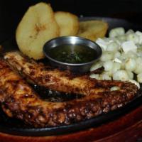 Pulpo Anticuchera · Grilled octopus in aji panda anticuchera marinade. Served with golden potatoes, corn and che...