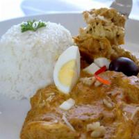 Aji de Gallina · Shredded chicken in a Peruvian yellow pepper sauce served with potatoes, egg, botija olive, ...