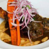 Seco de Res · A cilantro beef stew made with Peruvian spices, served with beans and white rice.