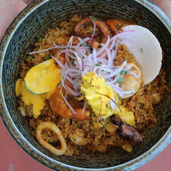 Arroz con Mariscos · Seafood combined with squid, shrimp, scallops, octopus and mussels, mixed with rice, peppers and spices.