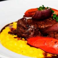 Risotto Huancaina con Lomo · Arborio rice in creamy huancaina sauce topped with stir fried beef tenderloin, onion, tomato...