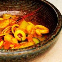 Cau Cau de Mariscos · Select variety of seafood in a yellow minty sauce with white rice.