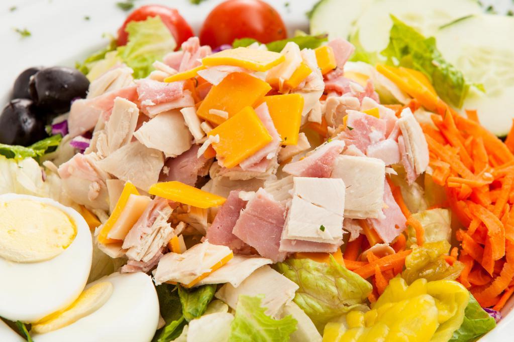 Cobb Salad · Chopped turkey on a bed of lettuce with tomatoes, avocado, bleu cheese crumbles, chopped egg, carrot, black olives and Italian dressing.