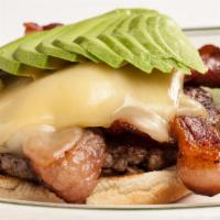 Avocado Burger with Bacon · Mel burger with sliced avocado, onion, Jack cheese and crisp bacon. Gluten free possible.