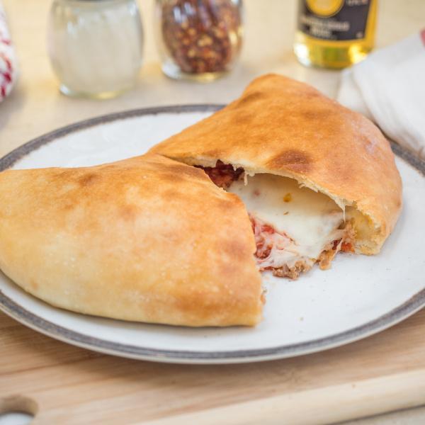 Calzones · Homemade sauce, mozzarella cheese and wrapping in pizza dough and stone baked to golden perfection.