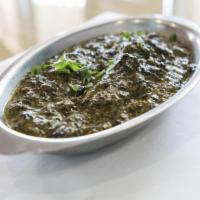 Chicken Saag · Boneless chicken pieces cooked in a creamy spinach puree and fresh herbs.