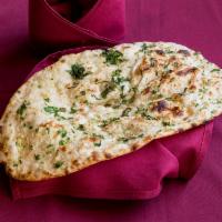 Garlic Naan · White leavened garlic-sprinkled bread baked in clay oven.