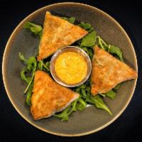 Spanakopita · Crispy baked phyllo dough stuffed with spinach and feta served with Santa Fe Sauce.