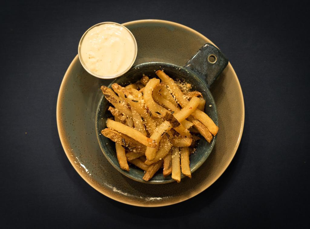 French Fries · Hand cut Idaho potatoes, roasted and flash fried, tossed with garlic, rosemary and parsley and parmesan, with Garlic Aioli. (V, GF)