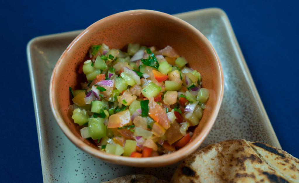 Israeli Salad · Chopped tomatoes, cucumbers, onions and parsley tossed in lemon juice and extra virgin olive oil. (V, GF)