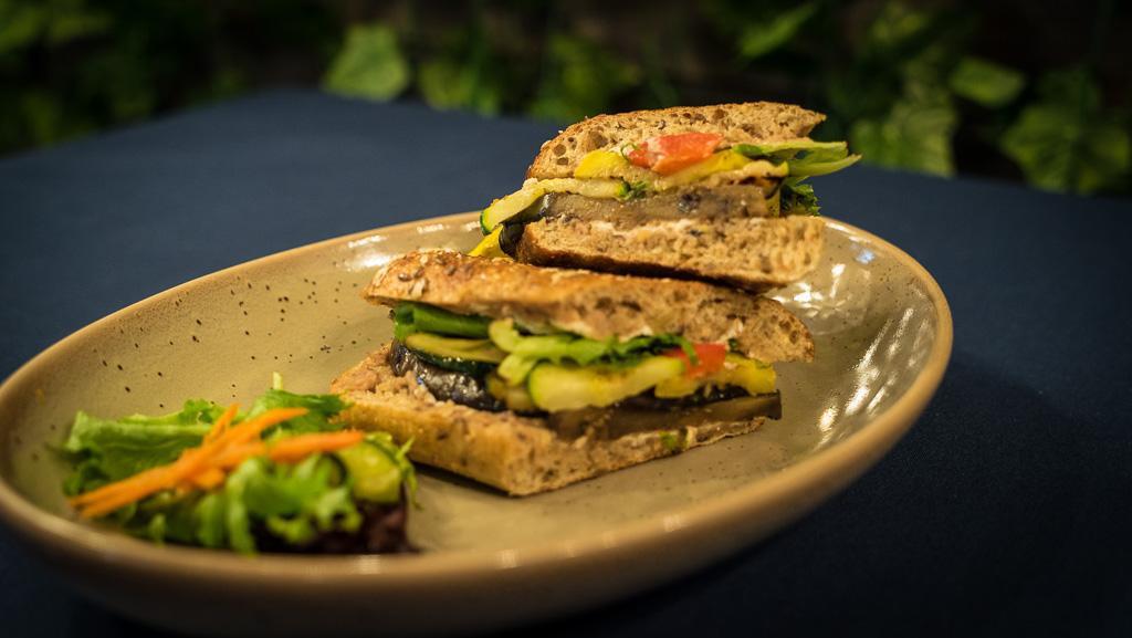 Vegetable & Goat Cheese Panini · Mixed greens, grilled eggplant, zucchini, yellow squash, roasted red pepper, goat cheese, Kalamata olive spread, on a multigrain ciabatta. Served with house pickles and supergreen slaw.