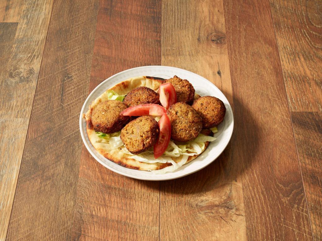 Falafel Sandwich · Mixture of garbanzo and fava beans, deep fried with spices and chopped parsley. Wrapped in pita with tomatoes, lettuce, onions, parsley and side yogurt sauce.
