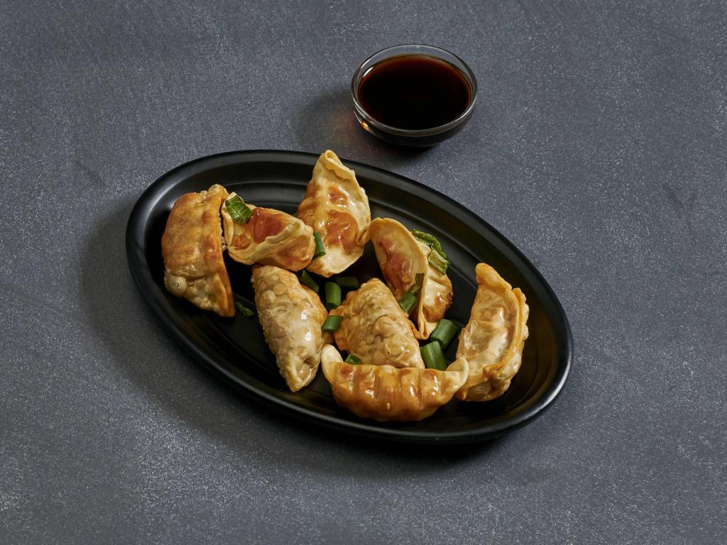2. Pot Stickers · Steamed or lightly fried spring roll wraps stuffed with chicken and vegetable. Topped with fried garlic and green onions. Served with soy sauce. *Steamed potstickers are tossed with sesame oil.
