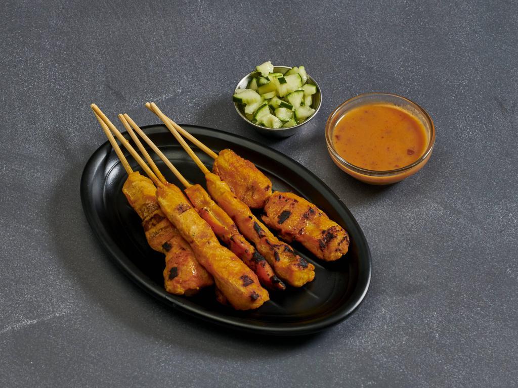 5. Chicken Satay · Chicken marinated in Thai spices, grilled on a skewer and served with peanut sauce and cucumber salad. 