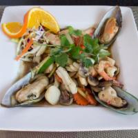 64. Combination Seafood · Stir fried shrimp, calamari, fish ball, crab clam, green mussel, ginger, carrot, onion, mush...