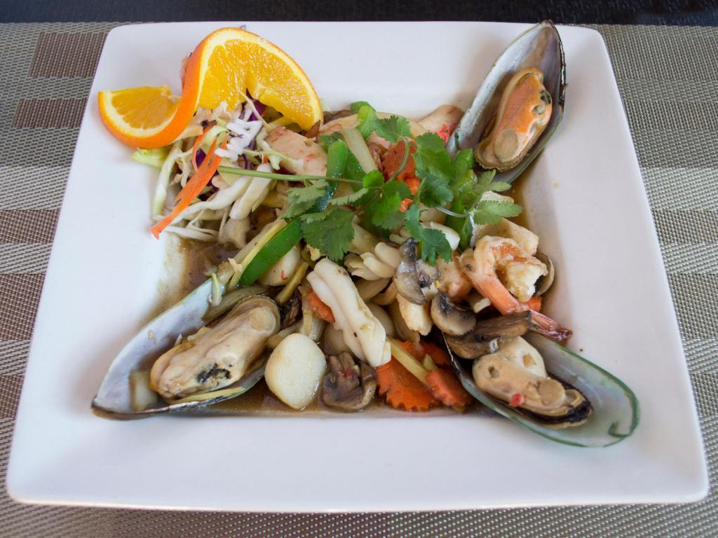 64. Combination Seafood · Stir fried shrimp, calamari, fish ball, crab clam, green mussel, ginger, carrot, onion, mushroom, bell pepper, and basil leaves. Served with steamed rice. Spicy.