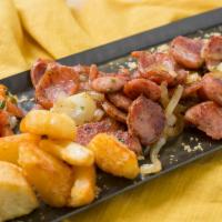 Linguica Frita with Yucca · Sauteed Brazilian style sausages with onions and yucca, served with yucca flour and salsa.