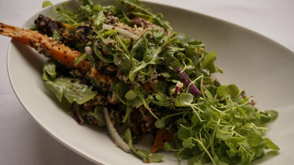 Quinoa Salad · High in protein quinoa salad tossed with sweet potatoes, red onions, Gorgonzola, candied walnuts, cilantro and arugula. Garnished with micro watercress and roasted tomatoes. Tossed with our homemade raspberry vinaigrette dressing.