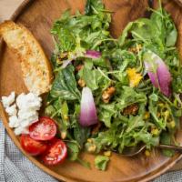 Gabriela's Regular Salad · Fresh spinach, arugula, fresh basil, goat cheese, candied walnuts, croutons, red onions, cho...