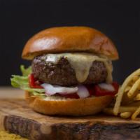 Bossa Cheeseburger · A huge open face charbroiled burger with a whopping Black Angus half-pound patty, white Ched...