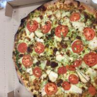 Pesto Chicken Pizza · Pesto sauce, chicken, mozzarella cheese, tomatoes and fresh garlic.