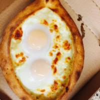 Ajarski Khachapuri · Feta cheese, mozzarella cheese and eggs. Add 1 topping for an additional charge.