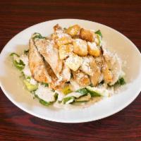 Caesar Salad · Bed of romaine lettuce, Parmesan cheese, croutons, and creamy Caesar dressing.