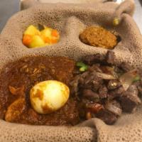 18. Combination 1  · For one. #1 chicken wot and #10 beef tibbs with 2 vegetables. Served with injera.