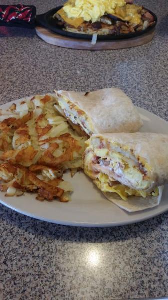 Breakfast Burrito · 3 scrambled eggs in a tortilla with cheese, salsa, sour cream and choice of breakfast meat. Comes with a side of hash browns.