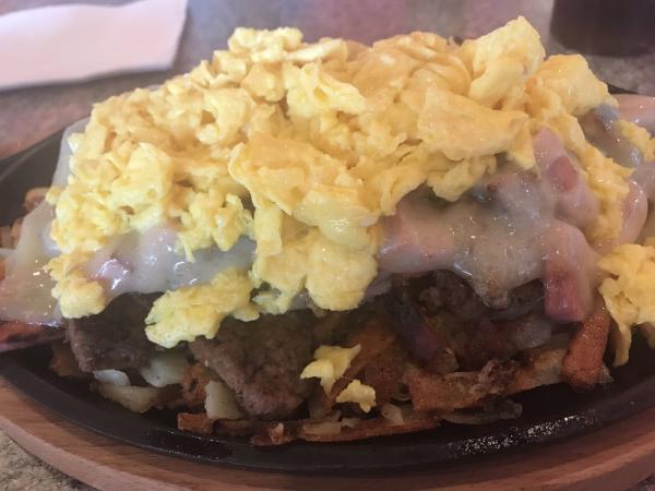 Meat Skillet · Bacon, ham, sausage, ground beef and cheddar served on a bed of hash browns with 2 eggs on top and a side of toast.