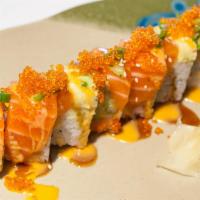 Kintai Roll · Inside: shrimp tempura, cream cheese and cucumber. Outside: avocado, salmon, tobiko and gree...