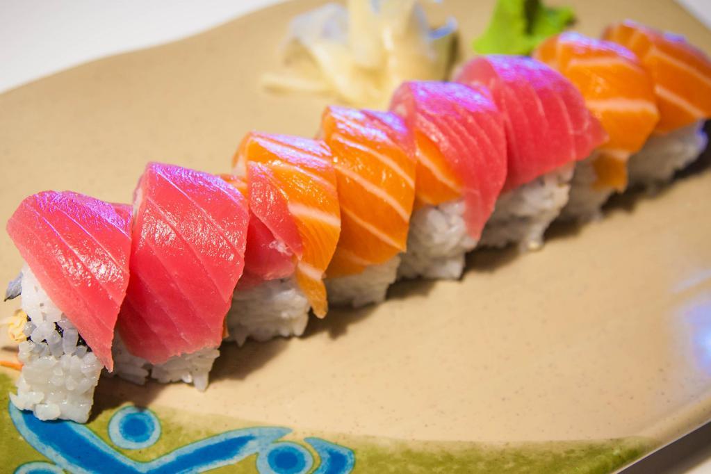 Passion Roll · Inside: salmon, tobiko, cucumber and avocado. Outside: salmon and tuna.