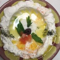 Lebneh · Kefir cheese topped with dried mint and live oil and served with pita bread.