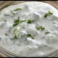 Cucumber Yogurt · Fresh yogurt blended with diced cucumber, dry mint, garlic and lemon juice.