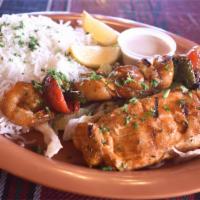Grilled Seafood Kabob · 1/2 pound of grilled salmon steak with a skewer of shrimp, scallops and veggies. Grilled to ...