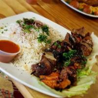 Lamb Kabob · 2 skewers of lamb pieces marinated in olive oil and spices with grilled onions and green bel...