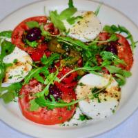 Caprese · Tomatoes, mozzarella, fire-roasted peppers, basil and extra virgin olive oil.
