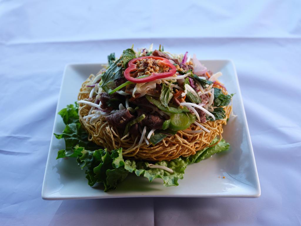 Beef Salad on Crispy Noodle · Thin-sliced beef, bean sprouts, jalapeno, bell pepper, cilantro, cabbage, carrots, scallions and mint leaves on crispy egg noodles.