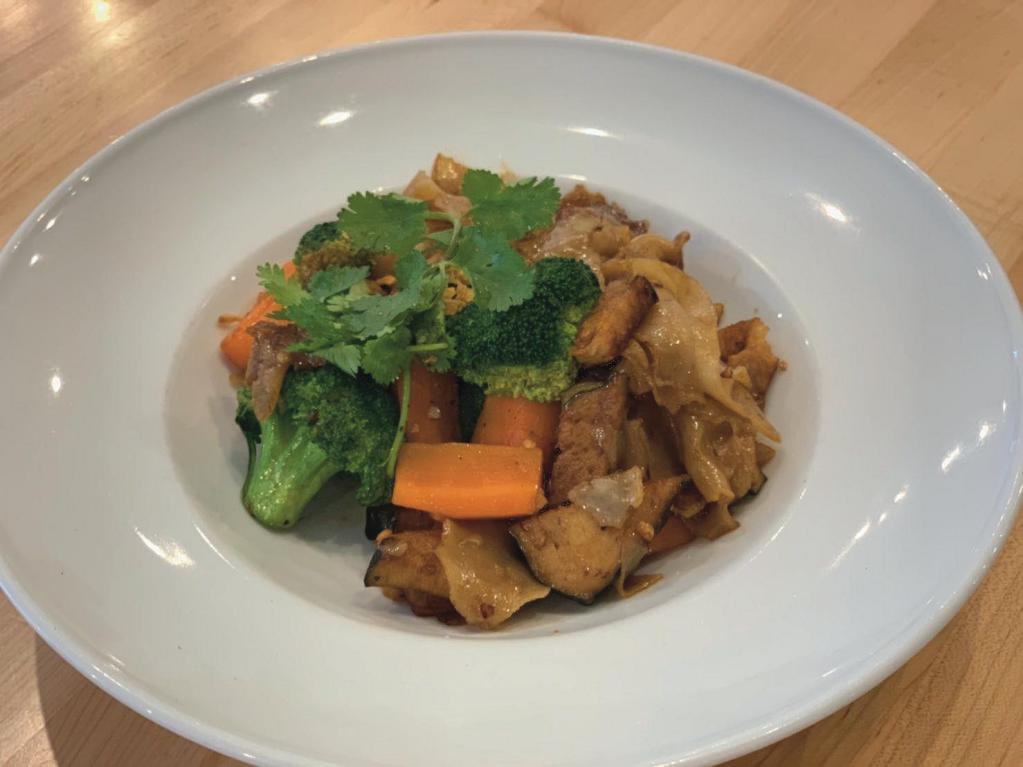 Pad See Ew Tofu (VEGAN) · Stir fried rice noodles, carrots, broccoli and tofu  with sweet soy sauce.