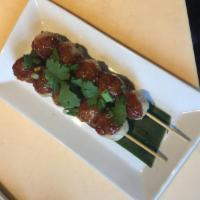 Luk Chin Ping · Grilled meatballs on a stick, served with spicy and tangy dipping sauce.